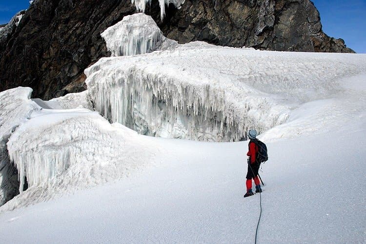 A climber beside Rwenzori glacier ice walls