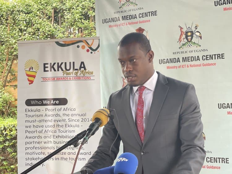 An official speaking at the Ekkula Tourism Awards launch, with an Ekkula banner behind him.