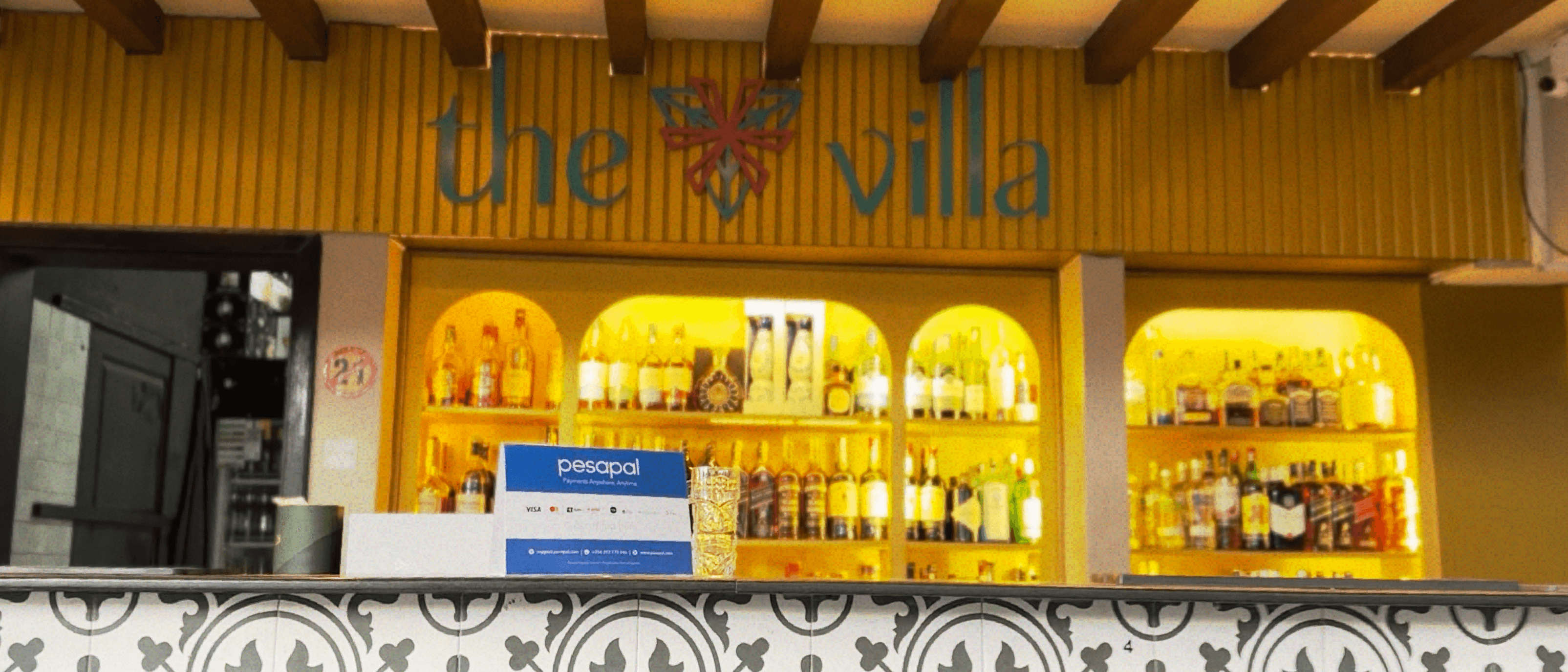 The Villa bar in Bukoto with its illuminated shelves and venue sign.