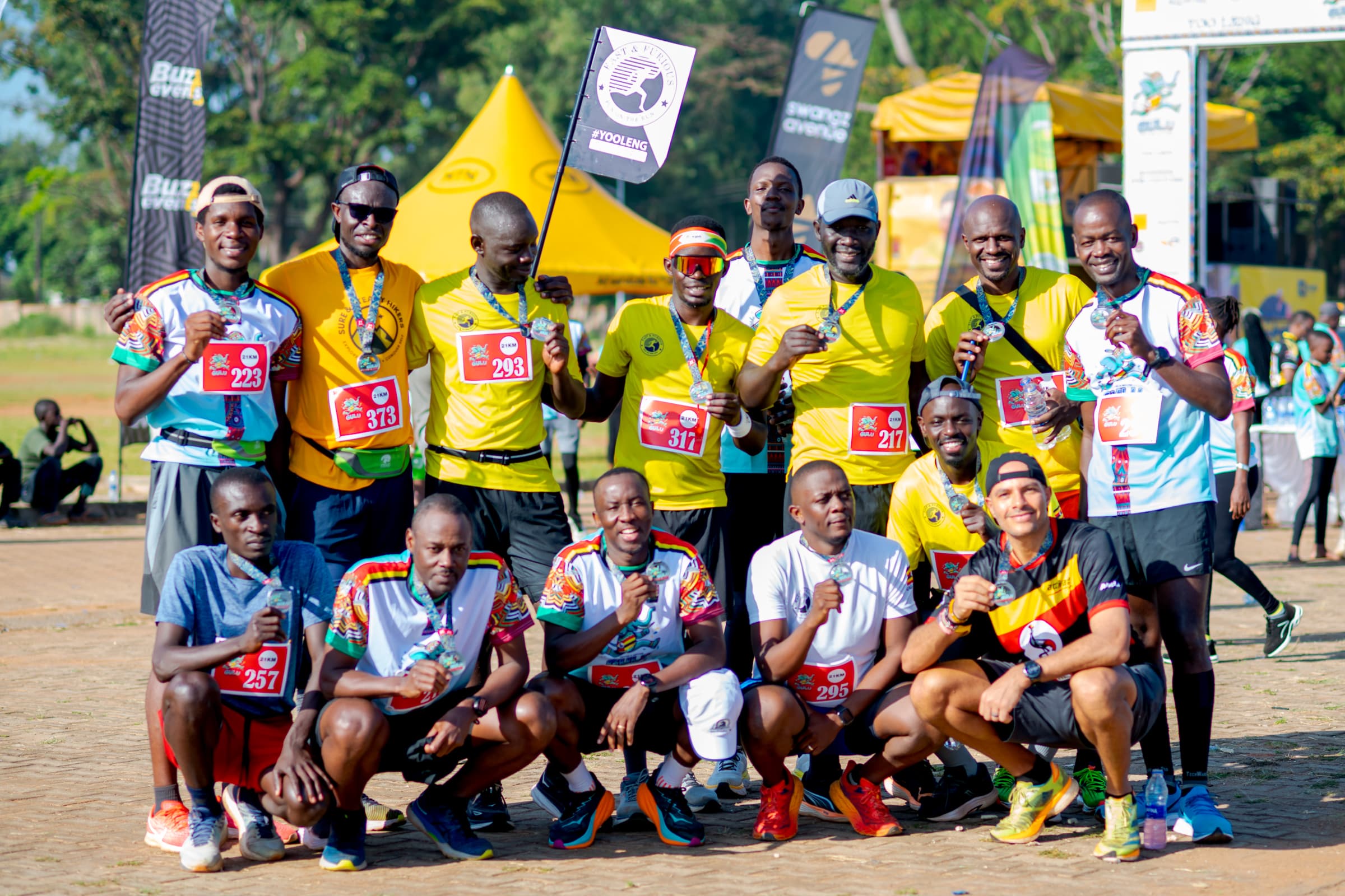Participants displaying medals in a photograph from a previous Gulu City Marathon.