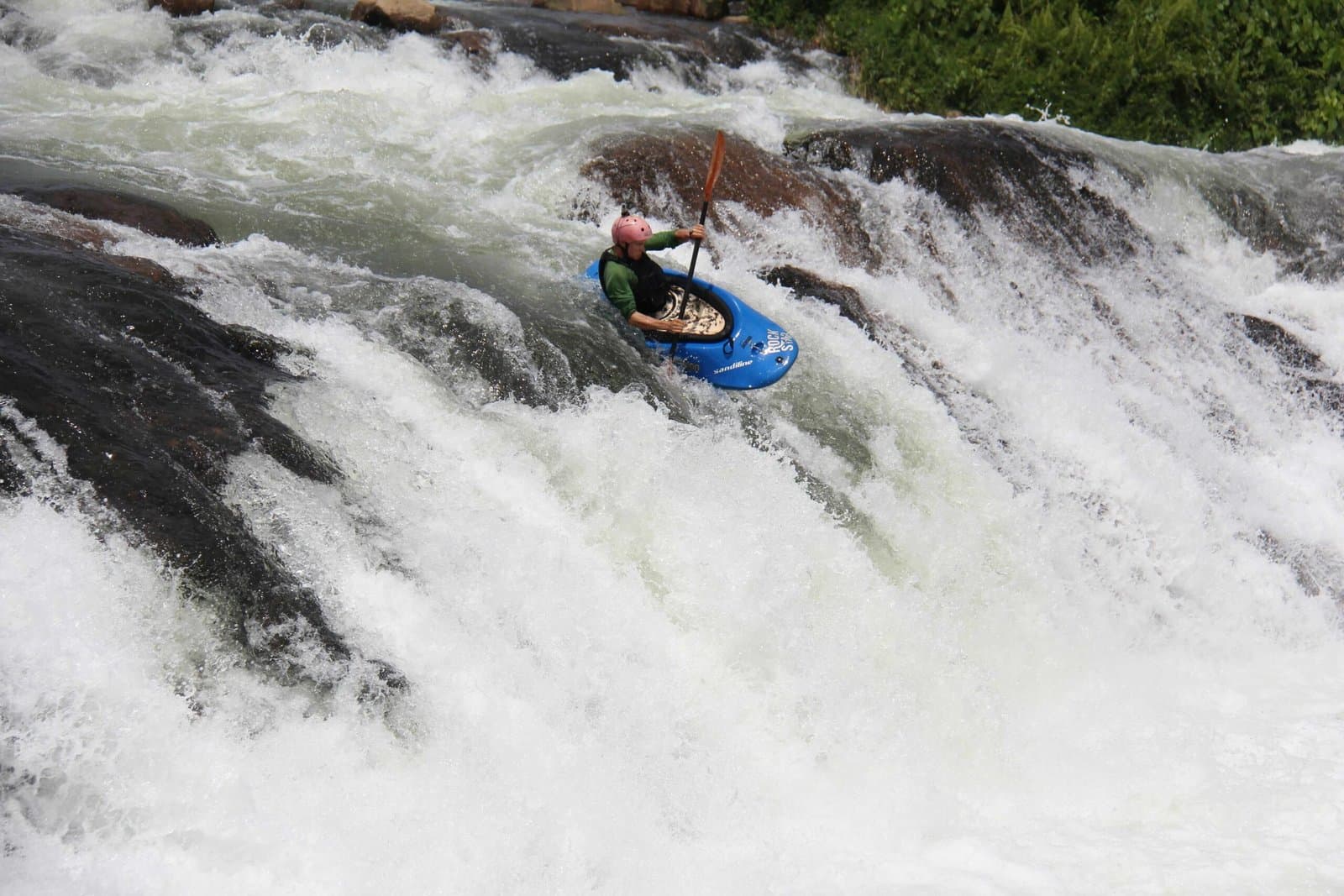 A kayaker navigating white water on the Nile