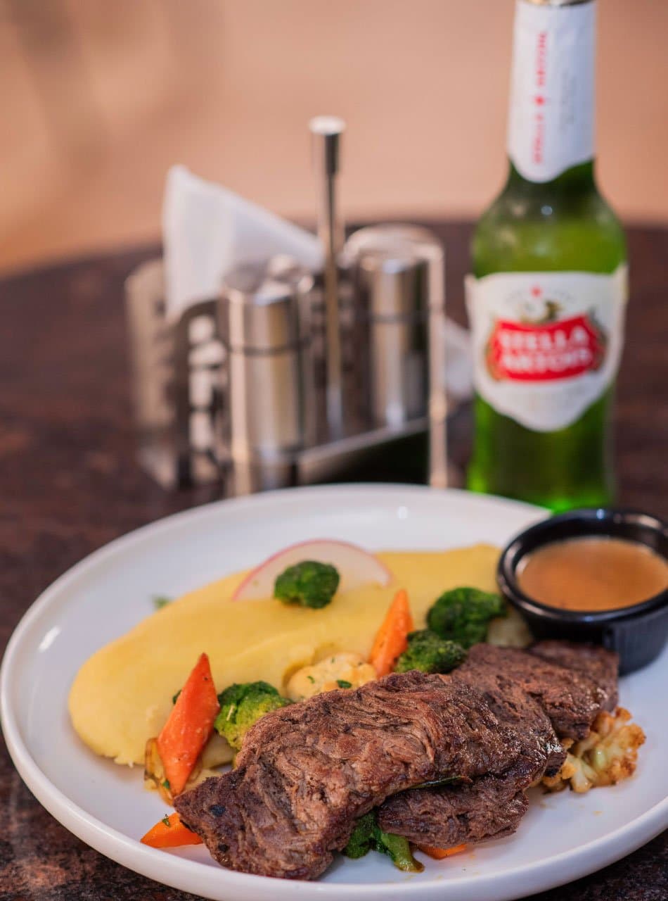 A grilled meal with vegetables in Silo 15 food photography published by EatOut Uganda.