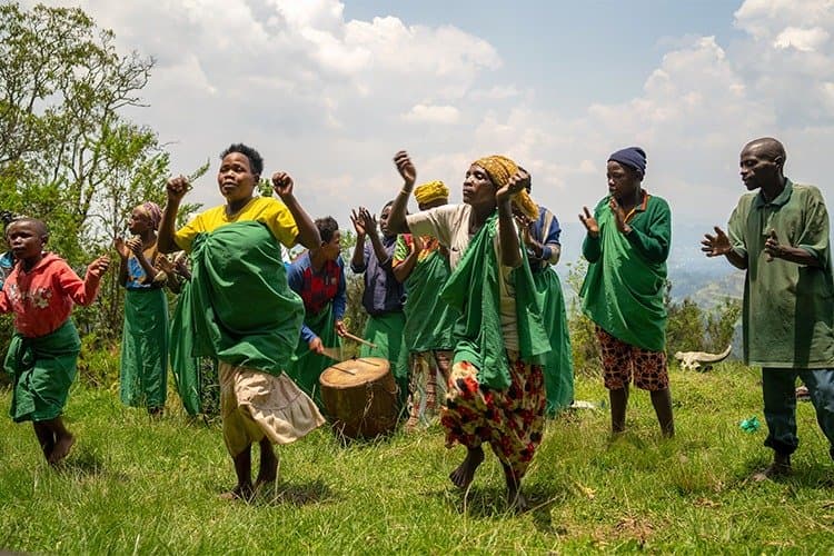 Batwa guides demonstrating forest skills